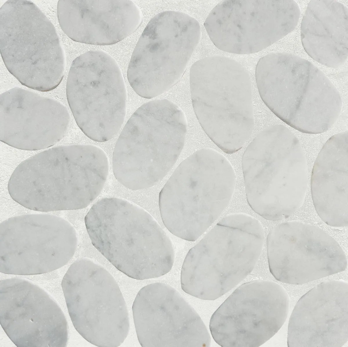 Slice carrara pebble tile sample close up with grout