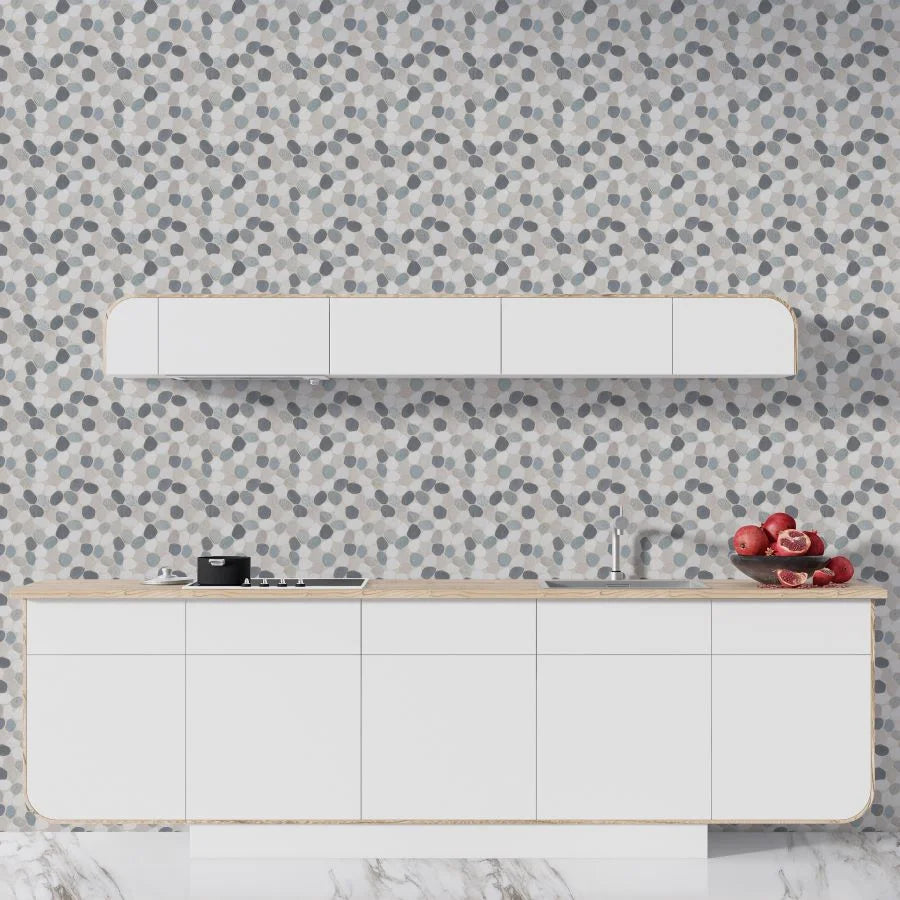 ibiza sliced pebble tile wall with a kitchen countertop in front of it