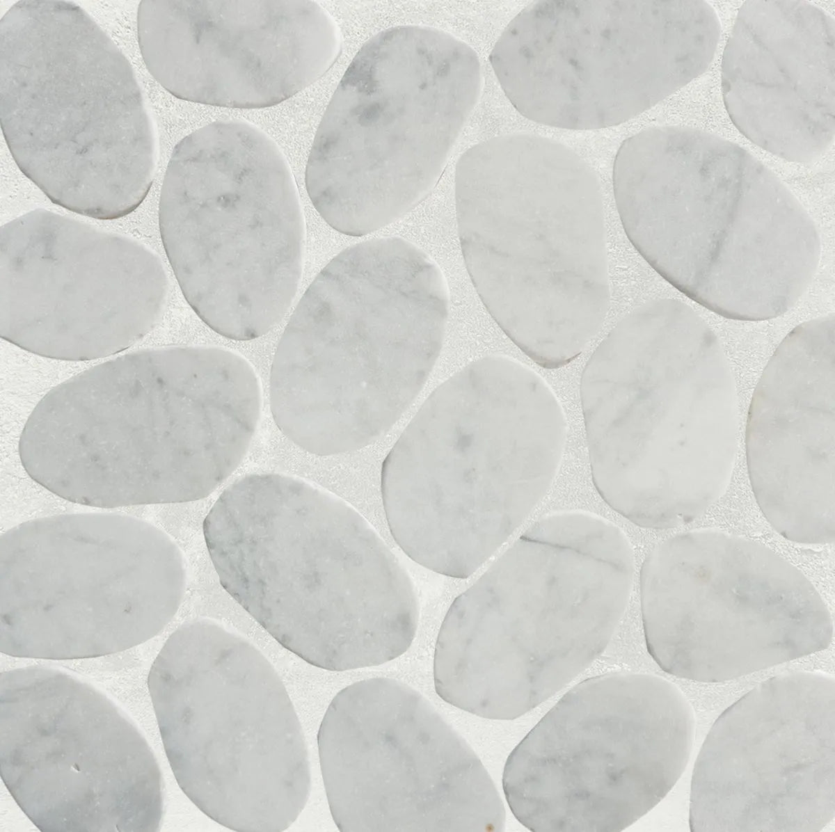 Slice carrara pebble tile sample close up with grout