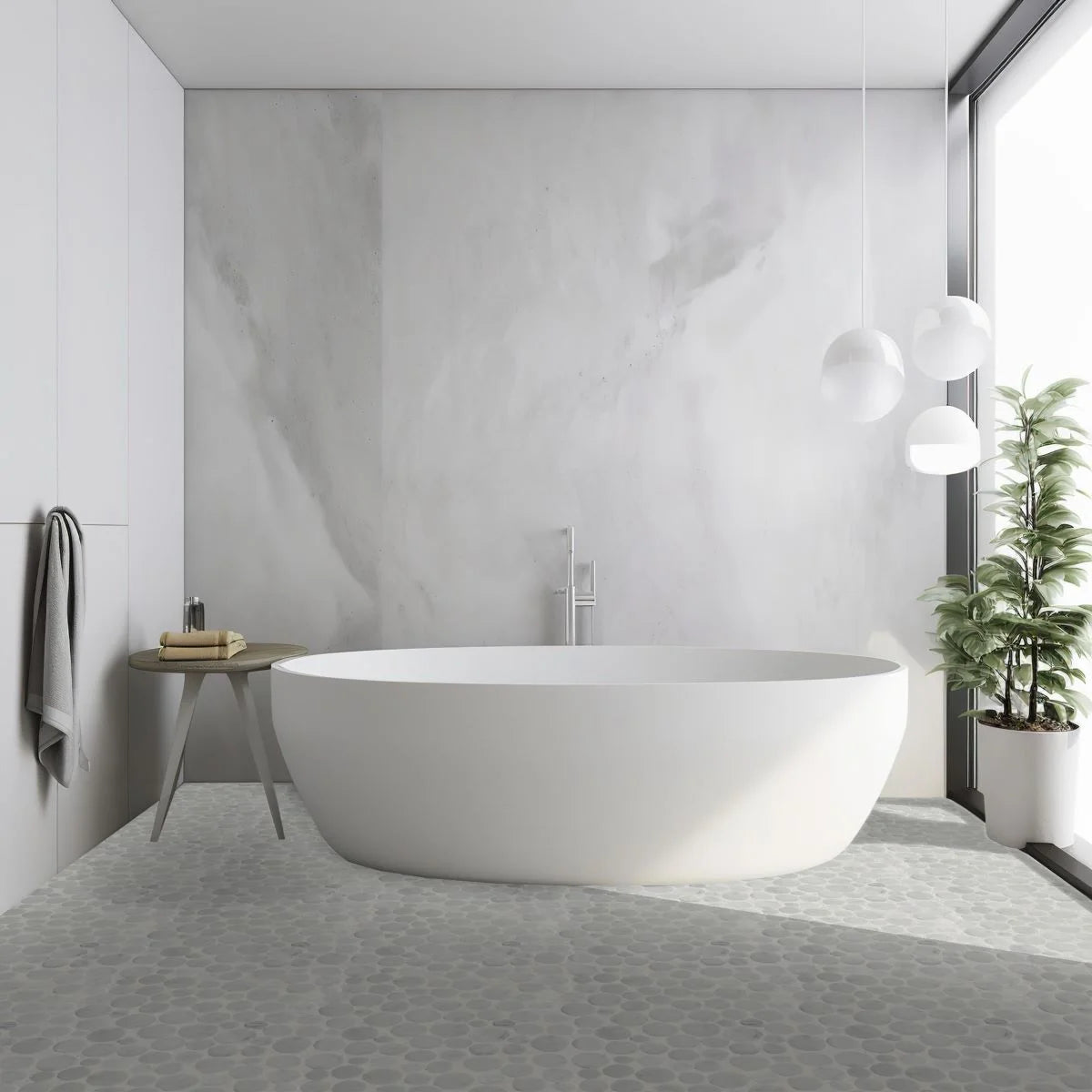 penny carrara pebble tile flooring with white bathtub sitting on top of it