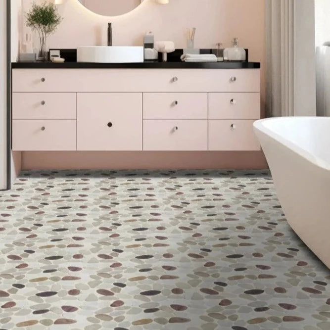 Cherry pebble tile flooring with pink bathroom countertop next to it