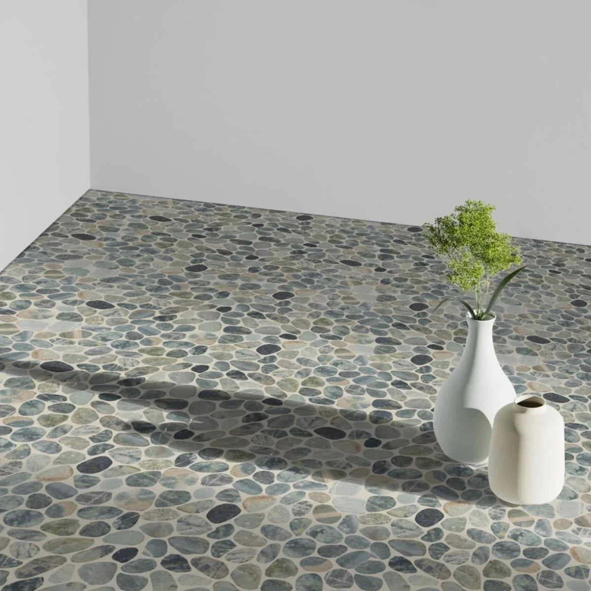 Teal Blue Sliced Pebble tile flooring with two small white vases sitting on top