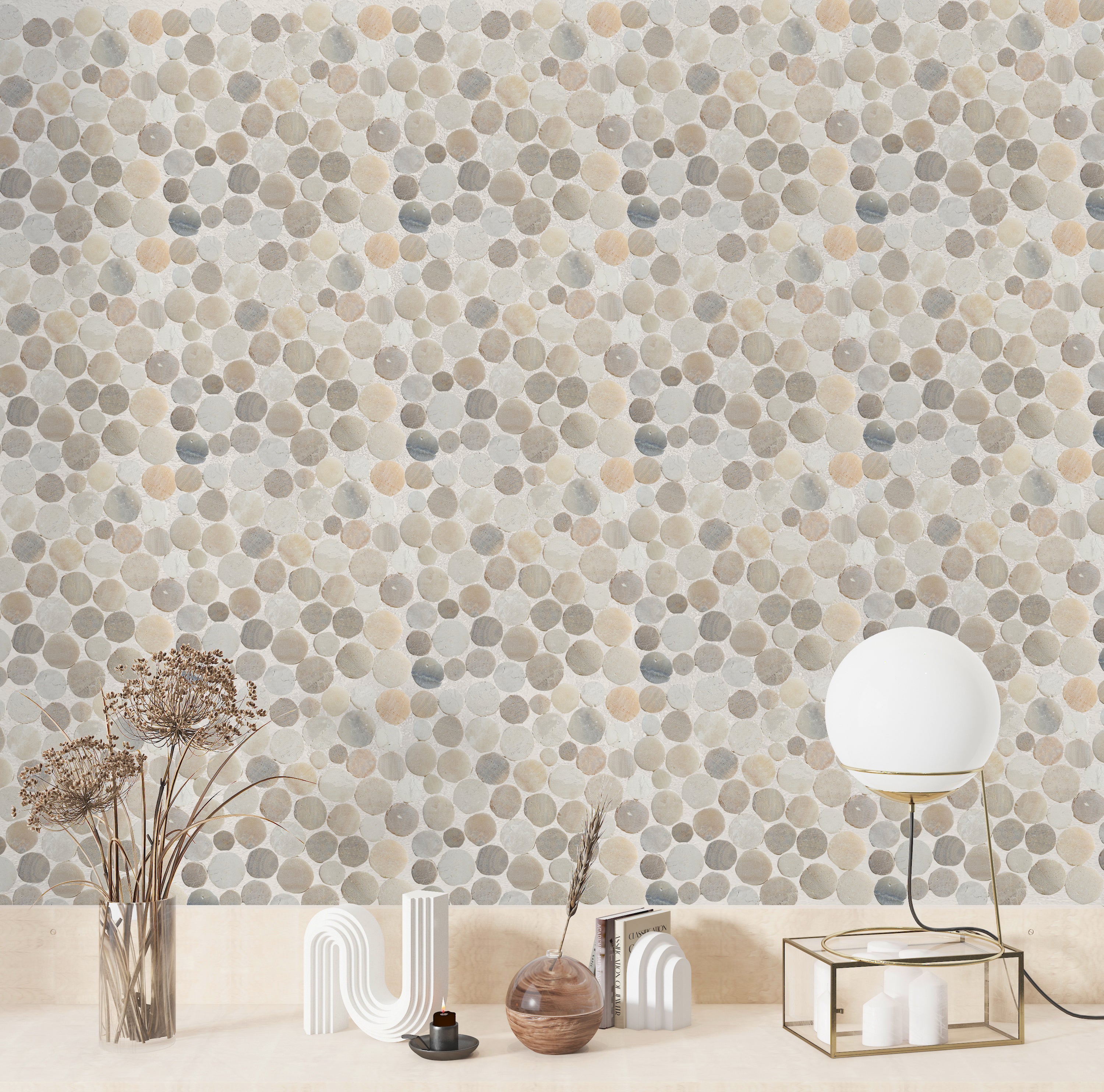 Sunset pebble tile wall with modern decor on counter in front of it
