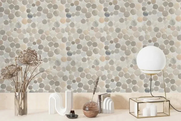 sunset round pebble tile wall with modern decorations on counter in front of it